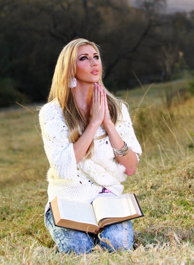 Lady praying in park