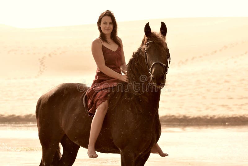 Lady in red on black horse royalty free stock images Lady in red on black horse royalty free stock images