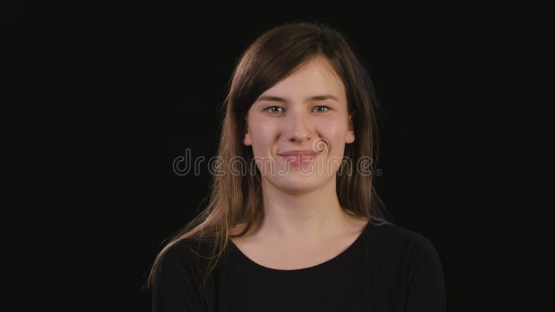 Lady`s Face Smiling Against a Black Background