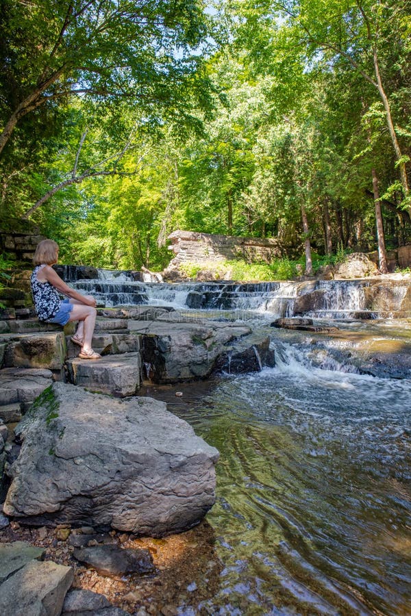 Lady Sitting Next To the Devils River Falls in Maribel, Wisconsin