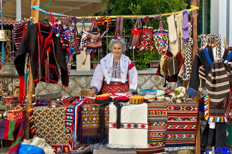 Lady in traditional clothes selling on booth stock images Lady in traditional clothes selling on booth stock images