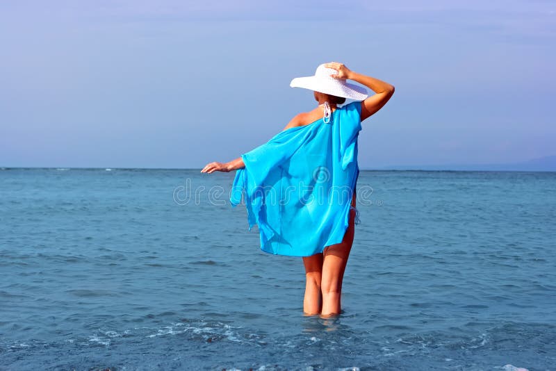 Lady in white hat in water