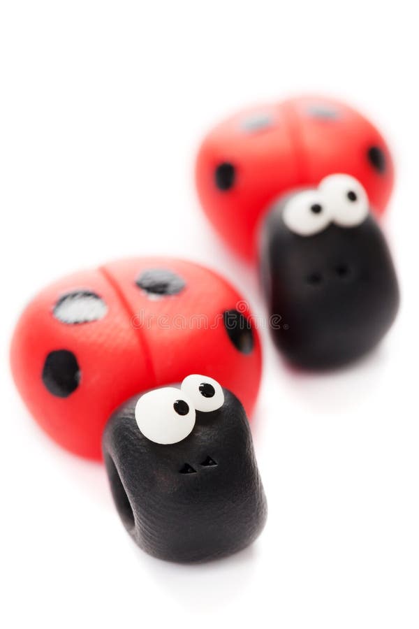 Ladybirds made of polymer clay isolated on white background