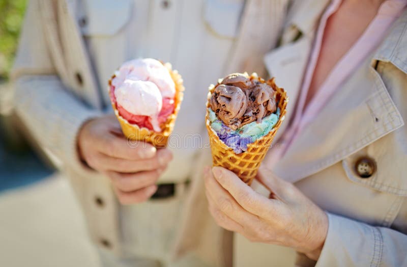 Tasty ice-cream in hands of senior couple. Tasty ice-cream in hands of senior couple