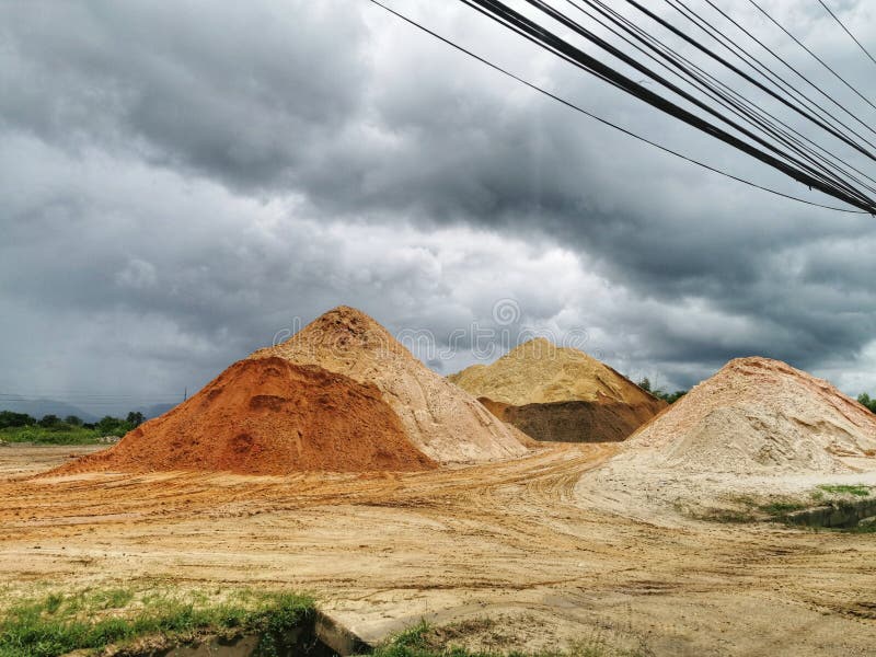 Caroni, Trinidad and Tobago- May 2nd, 2021: A stockpile of aggregates at the side of the Valencia Road. These aggregates were being used for road construction. Caroni, Trinidad and Tobago- May 2nd, 2021: A stockpile of aggregates at the side of the Valencia Road. These aggregates were being used for road construction.