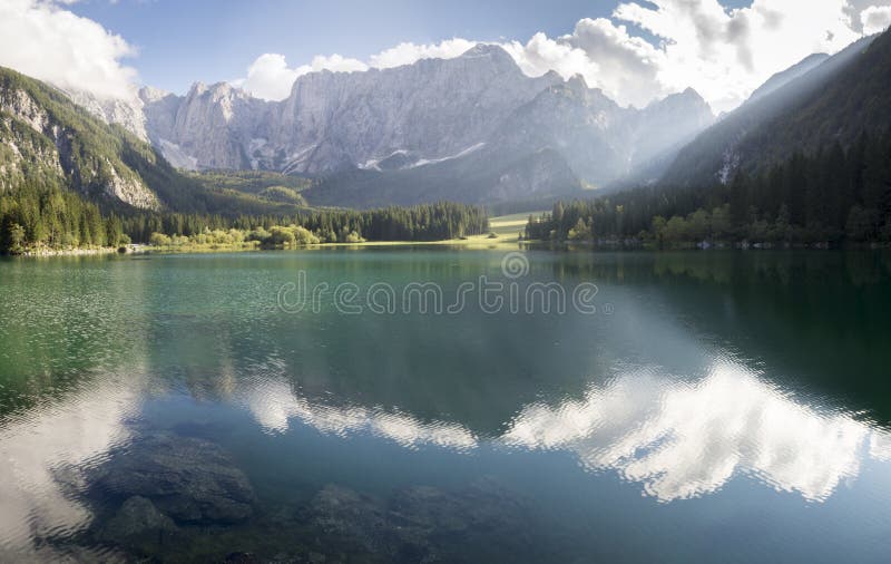 Alpine lake,Sunrise over the alpine lake Laghi di Fusine,Italy,Julian Alps. Alpine lake,Sunrise over the alpine lake Laghi di Fusine,Italy,Julian Alps