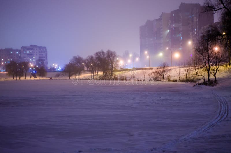 Lago della città di inverno alla notte Lago coperto di ghiaccio e lanterne leggere arancio fotografie stock libere da diritti Lago della città di inverno alla notte Lago coperto di ghiaccio e lanterne leggere arancio fotografie stock libere da diritti
