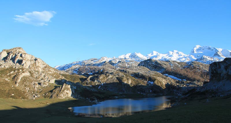 Lake Ercina is a small highland lake in Asturias, Spain. It is a lake of glacier origin, located in the Picos de Europa, in the Cantabrian Mountains. Situated next to Lake Enol, together, they forms the group known as Lakes of Covadonga within the Picos de Europa National Park. Lake Ercina is smaller than Lake Enol. It is situated at an altitude of 1,108 metres and its maximum depth is just over 3 metres. The eutrophic lake, covers approximately eight hectares. In the background the Tower of Santa Maria, Peña Santa de Enol or Peña Santa de Asturias, 2,478 m., located in the Western Massif of the Picos de Europa or Macizo del Cornión; and the Pico Llucia to the left. Lake Ercina is a small highland lake in Asturias, Spain. It is a lake of glacier origin, located in the Picos de Europa, in the Cantabrian Mountains. Situated next to Lake Enol, together, they forms the group known as Lakes of Covadonga within the Picos de Europa National Park. Lake Ercina is smaller than Lake Enol. It is situated at an altitude of 1,108 metres and its maximum depth is just over 3 metres. The eutrophic lake, covers approximately eight hectares. In the background the Tower of Santa Maria, Peña Santa de Enol or Peña Santa de Asturias, 2,478 m., located in the Western Massif of the Picos de Europa or Macizo del Cornión; and the Pico Llucia to the left.