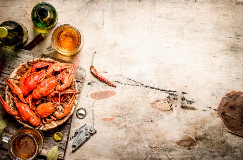 Fresh boiled crawfish with beer. On Wooden background. Fresh boiled crawfish with beer. On Wooden background.