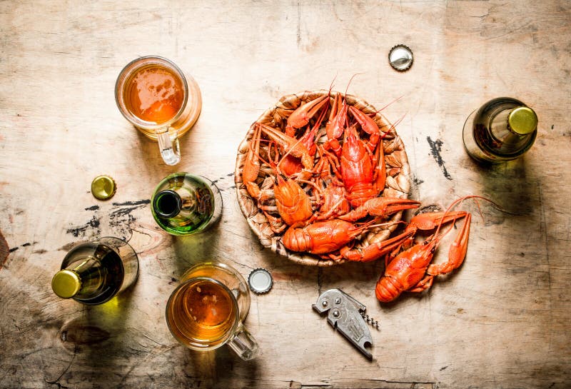 Fresh boiled crawfish with beer. On Wooden background. Fresh boiled crawfish with beer. On Wooden background.