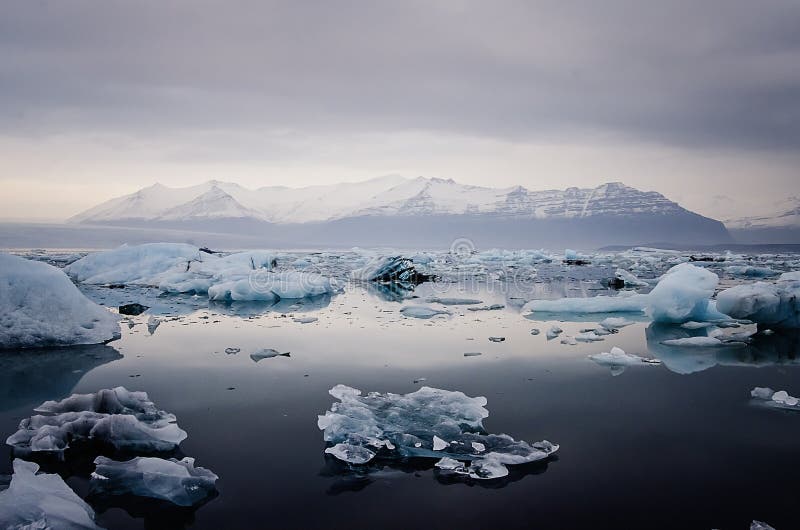 Mystical lagoon full of icebergs at Jokulsarlon Glacier lagoon in southern Iceland. The icebergs are 1.000-year-old chunks of the retreating Oraefajokull glacier that have broken off and are floating out to sea. Mystical lagoon full of icebergs at Jokulsarlon Glacier lagoon in southern Iceland. The icebergs are 1.000-year-old chunks of the retreating Oraefajokull glacier that have broken off and are floating out to sea.