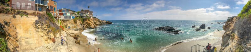 LAGUNA BEACH, CA - JULY 31, 2017: Tourists visit city beach on a beautiful summer day. Laguna Beach is a tourist attraction in California. LAGUNA BEACH, CA - JULY 31, 2017: Tourists visit city beach on a beautiful summer day. Laguna Beach is a tourist attraction in California.