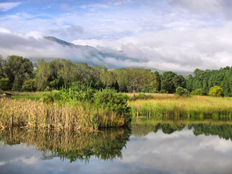 Lake against misty mountains royalty free stock photo Lake against misty mountains royalty free stock photo