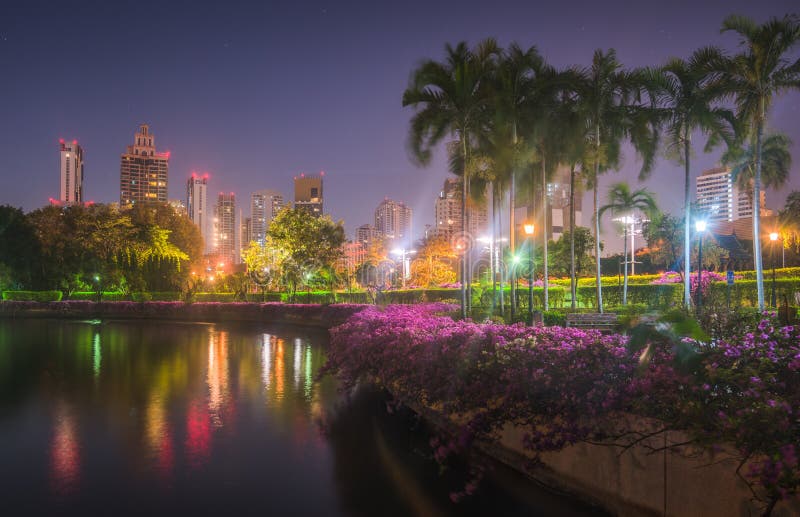 Lake with Calm Water Reflecting Nearby Buildings in South Part of Benjakiti Public Park at Night in Bangkok, Thailand. Lake with Calm Water Reflecting Nearby Buildings in South Part of Benjakiti Public Park at Night in Bangkok, Thailand