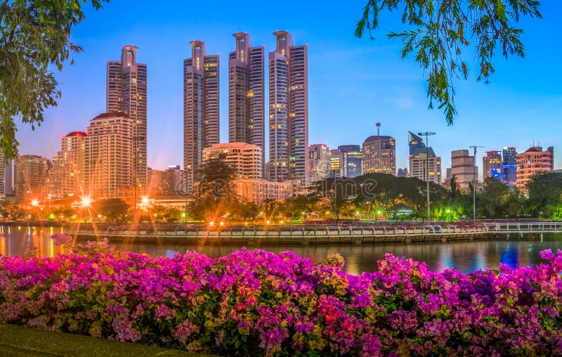 Lake in City Park under Skyscrapers at Night. Benjakiti Park in Bangkok, Thailand