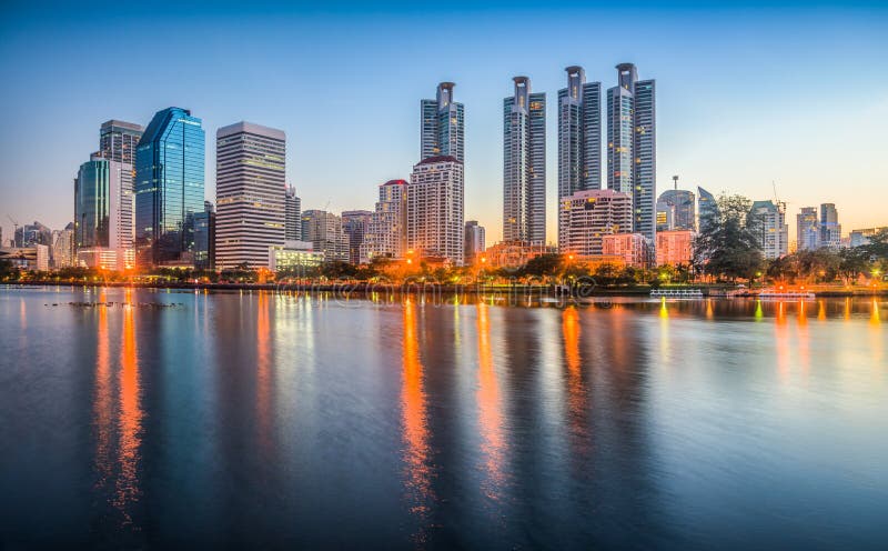 Lake in City Park under Skyscrapers at Twilight. Benjakiti Park in Bangkok, Thailand