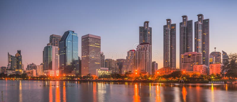 Lake in City Park under Skyscrapers at Twilight. Benjakiti Park in Bangkok, Thailand