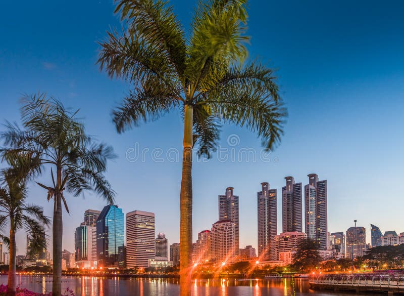 Lake in City Park under Skyscrapers at Twilight. Benjakiti Park in Bangkok, Thailand