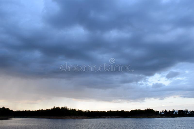 Lake and Dark blue stormy cloudy sky in evening royalty free stock images Lake and Dark blue stormy cloudy sky in evening royalty free stock images