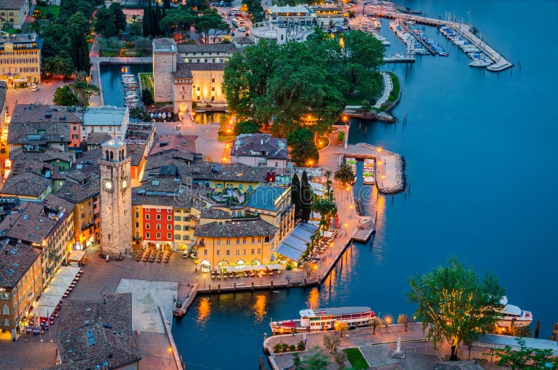Lake Garda, the Town of Riva del Garda at blue hour (Trentino, Italy), very popular touristic destination for Italians and Germans. Lake Garda, the Town of Riva del Garda at blue hour (Trentino, Italy), very popular touristic destination for Italians and Germans