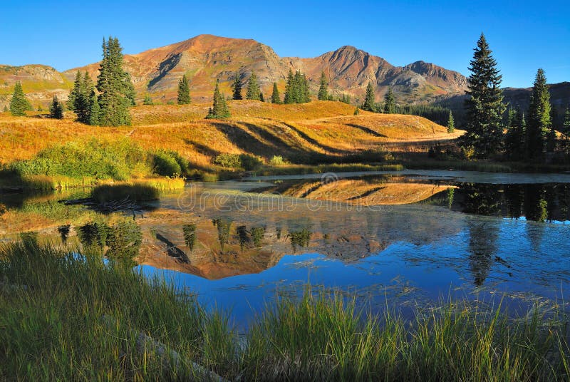 Lake and mountain landscape. Beaver Pond in Colorado next to Irwin Lake. Mountain and water reflection Fall landscape royalty free stock images Lake and mountain landscape. Beaver Pond in Colorado next to Irwin Lake. Mountain and water reflection Fall landscape royalty free stock images