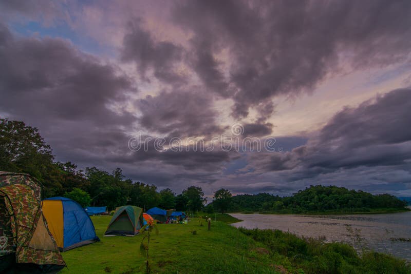 Tent spots along the reservoir in the middle of the forest Resting place cludy sky rain coming. Tent spots along the reservoir in the middle of the forest Resting place cludy sky rain coming