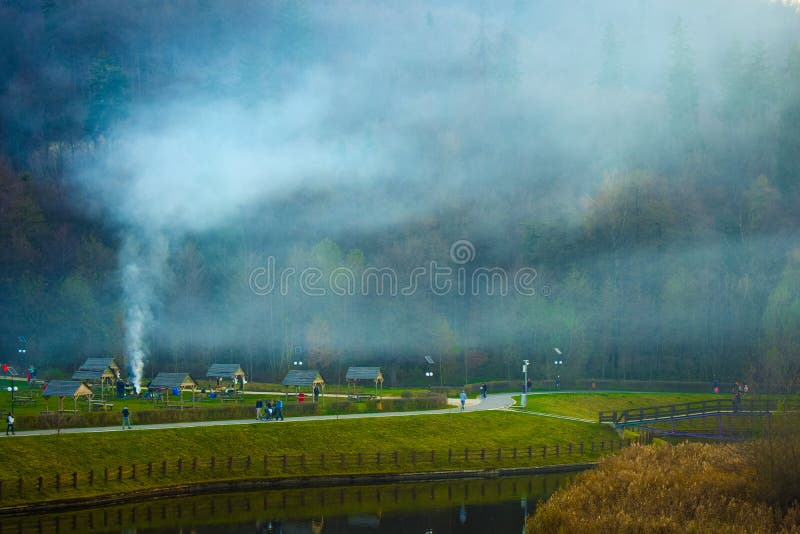 The lake park in the Noua district of Brasov Romania with barbecue smoke. Sunset colorful image. royalty free stock photo The lake park in the Noua district of Brasov Romania with barbecue smoke. Sunset colorful image. royalty free stock photo
