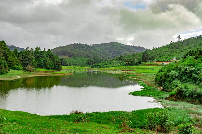 Lake pristine with mountain water reflection at morning image is taken at south india. it is showing the beautiful landscape of south india