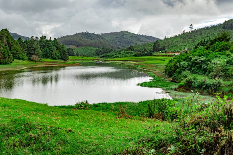 Lake pristine with mountain water reflection at morning image is taken at south india. it is showing the beautiful landscape of south india