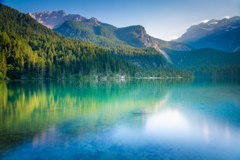 Idyllic Lake Tovel reflection symmetry in Trentino-Alto Adige, Italy. Idyllic Lake Tovel reflection symmetry in Trentino-Alto Adige, Italy
