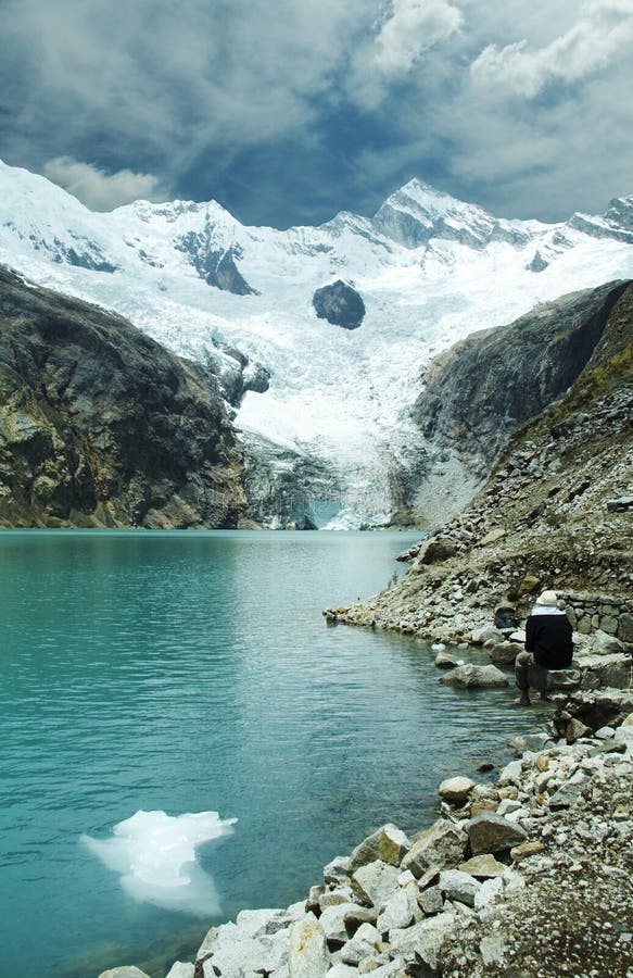 Mountain lake,iceberg and relaxing men. Mountain lake,iceberg and relaxing men