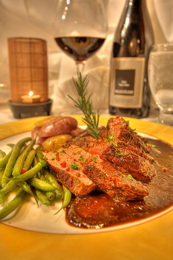 Lamb Entree Dinner with Wine in a Fine Dining Restaurant Stock Image