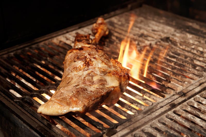 Lamb leg on charcoal grill stock photo. Image of grill 92820052