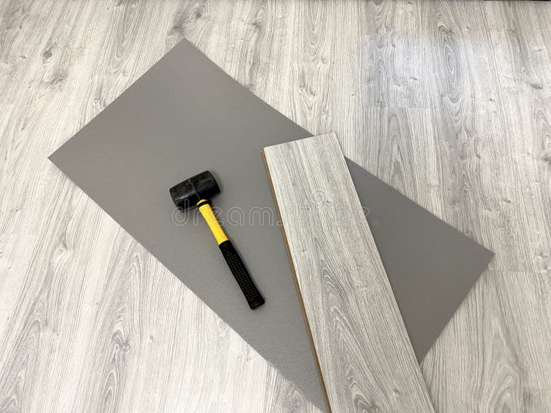 Laminate Floor Laying Tool, Underlay, Board and Hammer Stock Image