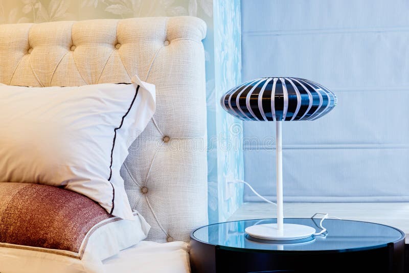 Lamp on bedside table in bedroom