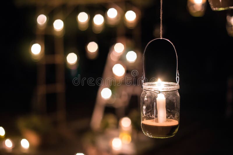 Lamp with Candle is Hanging on a Tree at Night. Wedding Nigh Stock