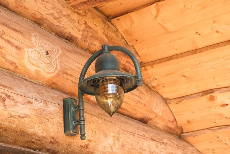 Lamp on the log house of chopped logs. royalty free stock image