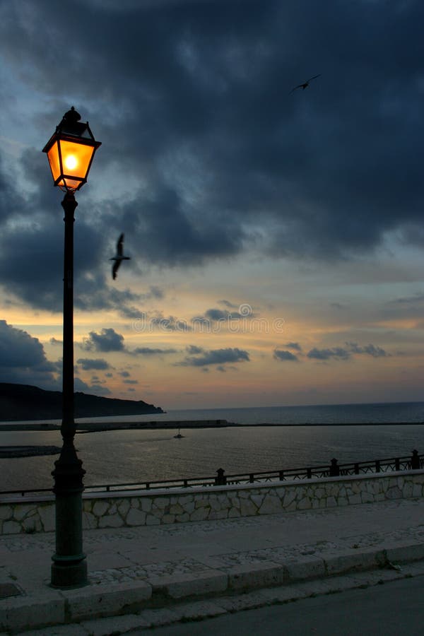 Lamp post in a dark sunset stock image. Image of city - 106852151