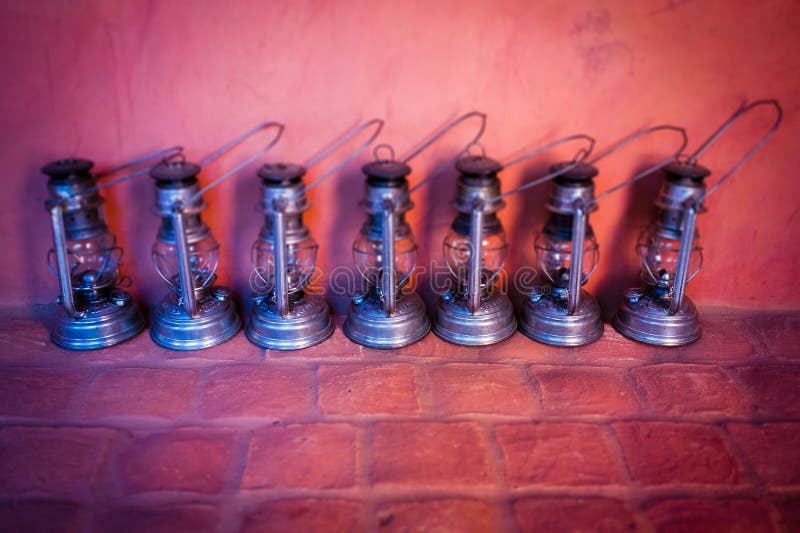 Seven Metal Oil Lamps shot on wall Background. Seven Metal Oil Lamps shot on wall Background