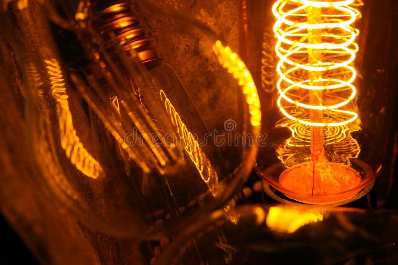 Lampadine incandescenti classiche Cobbled di Edison con i cavi d'ardore visibili nella notte fotografia stock libera da diritti Lampadine incandescenti classiche Cobbled di Edison con i cavi d'ardore visibili nella notte fotografia stock libera da diritti