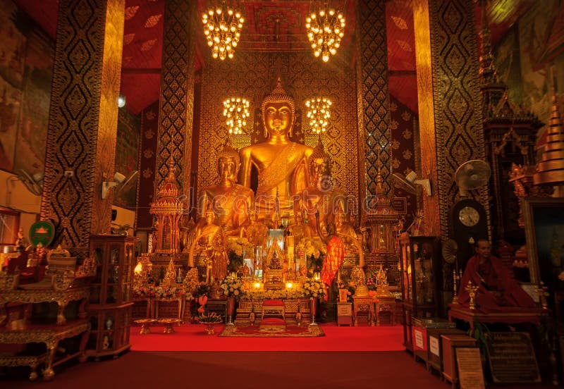 Lamphun, Thailand - May 20, 2018: Golden Buddha statues inside buddhist sanctuary of Wat Phra That Hariphunchai temple.