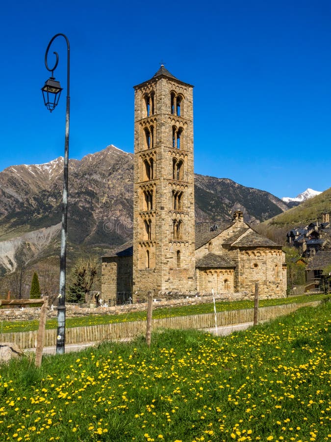 Lamppost in the Romanesque church of Taull, with the bell tower and the abside in the foreground. Montaña del Pirieno, Vall de Boi, Unesco Heritage, Catalonia, Spain. Lamppost in the Romanesque church of Taull, with the bell tower and the abside in the foreground. Montaña del Pirieno, Vall de Boi, Unesco Heritage, Catalonia, Spain