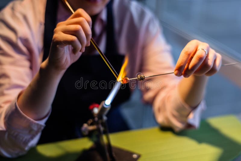 Woman Using Torch On Glass For Glass Blowing High-Res Stock Photo