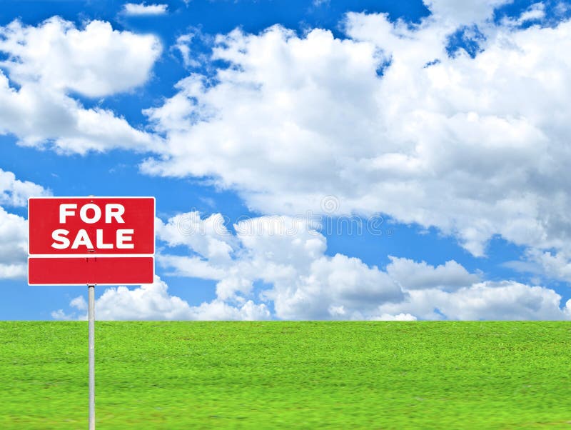 LAND FOR SALE SIGN on empty meadow - Real estate conceptual image.