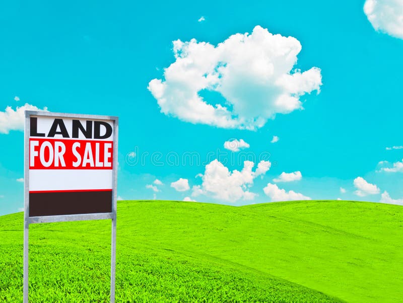 \ LAND FOR SALE SIGN\  on empty meadow - Real estate conceptual image