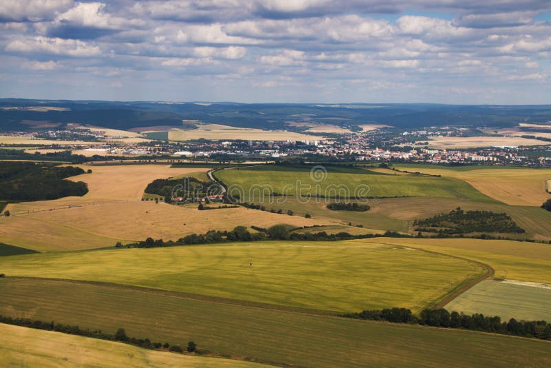 Landcsape with green sunny meadows and fields and town in the background from bird eye perspective. Tree landcsape stock images, royalty-free photos and pictures