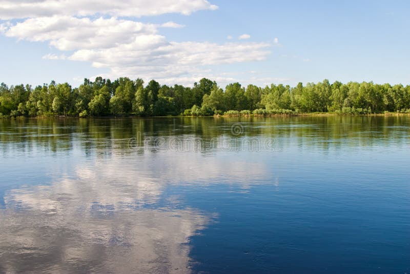 Landscape series: river and forest ander blu cloudy sky