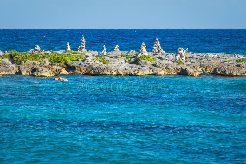 Landscape with balanced rocks, stones on a rocky coral pier. Turquiose blue Caribbean sea water. Riviera Maya, Cancun, Mexico.