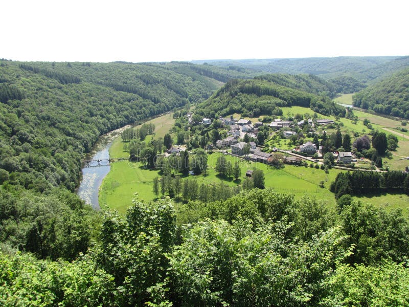 Aerial view at little village frahan in a green valley between the water of river semois and mountains with trees in the belgian ardennes in springtime. Aerial view at little village frahan in a green valley between the water of river semois and mountains with trees in the belgian ardennes in springtime
