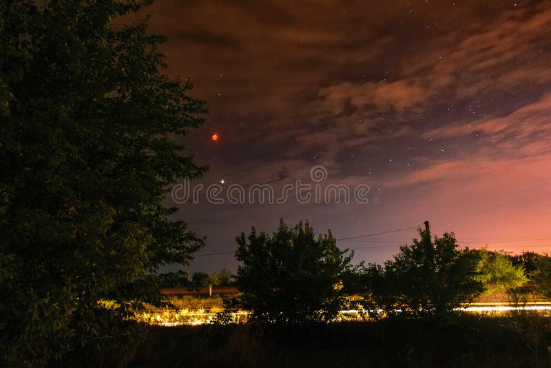 Full moon eclipse on the cloudy dark night sky stock image Full moon eclipse on the cloudy dark night sky stock image